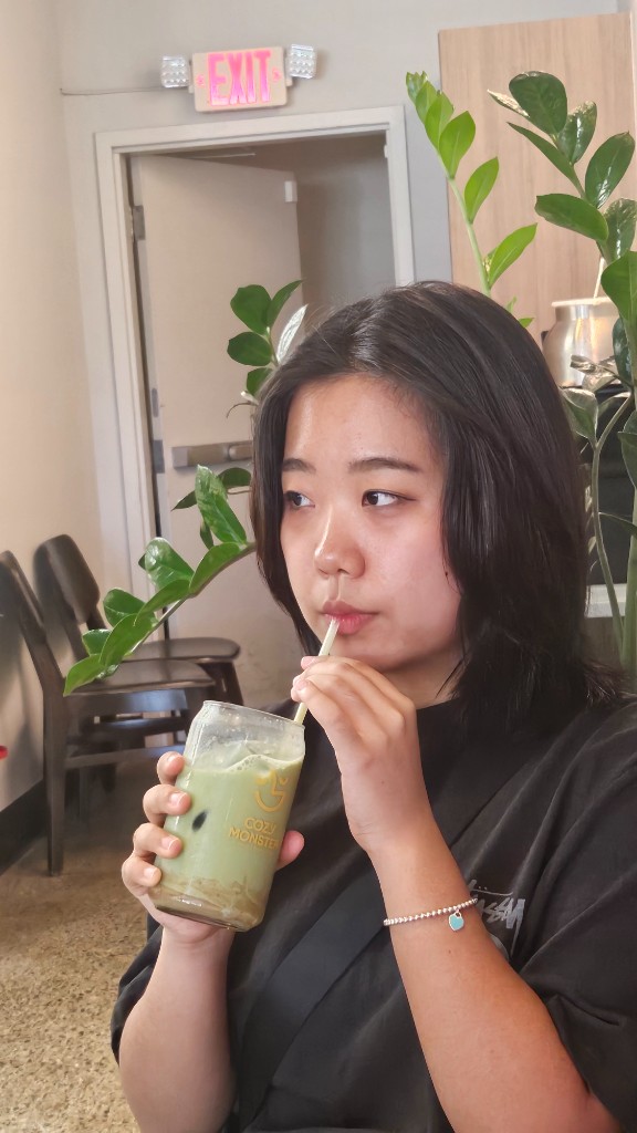 Amy drinking matcha at a cafe